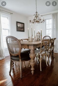 a dining room table with chairs and a chandelier