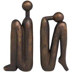 two bronze figurines sitting next to each other