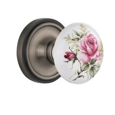 a door knob with a pink rose painted on the front and back of it's cover