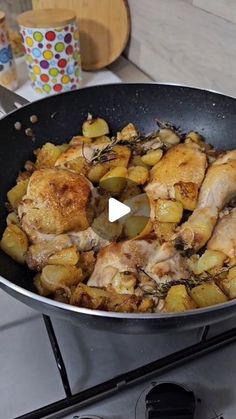 chicken and potatoes cooking in a skillet on the stove