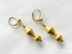 Earrings with 24ct old gold beads from Goa, filled with lac to prevent denting 3,0 cm long without the clasp The clasp is made of gold plated sterling silver, anti-allergic. 2,06 gram This is only a part of my collection, for more items please visit my website  www.m-beste.com There you will find a large selection of jewelry, figurines, textiles and other objects from India and Tibet. * * * Shipping  * * * All international shipping is free and TRACKED. The jewelry will be sent carefully wrapped Lovely Necklace, Goa, My Collection, Gold Plated Sterling Silver, Tibet, Gold Beads, My Website, Jewelry Earrings Dangle, Gold Earrings