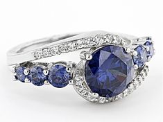 Pre-Owned Bella Luce ® Esotica ™ tanzanite and white diamond simulants 5.26ctw round, rhodium over sterling silver ring. Measures approximately 0.94"L x 0.44"W and is not sizable. .  This product may be a customer return, vendor sample, or on-air display and is not in its originally manufactured condition.  It may not be new.  In some instances, these items are repackaged by JTV. Fine Jewelry With Cubic Zirconia And Side Stones, Cubic Zirconia Jewelry With Side Stones For Gift, Anniversary Sapphire Jewelry With Side Stones, Blue Jewelry With Side Stones In Round Cut, Blue Round Cut Jewelry With Side Stones, Fine Silver Jewelry With Side Stones, Blue Wedding Jewelry With Side Stones, Man Made Diamonds, Diamond Simulant