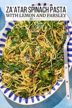 pasta with lemon and parsley in a bowl on a blue tablecloth next to a fork