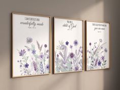 three framed art prints with flowers and bible verses on the wall in a room