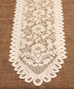 a table runner with white lace on it