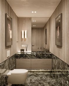 an elegant bathroom with marble counter tops and floor to ceiling mirrors on the wall above the toilet