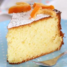 a piece of cake with powdered sugar on top is sitting on a blue plate