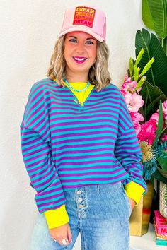 Get ready to bring the '80s vibe to life with the Real Retro Top! This long sleeve pullover boasts a vibrant yellow, purple, and teal striped pattern, making it a standout piece. Perfect for pairing with denim, leggings, or even over a tennis dress, this top's oversized fit lets you dress it up or down with ease. Rock it at a weekend brunch, a casual day out, or even a fun retro-themed party, especially when you add a trucker hat for that extra flair. PRODUCT FIT - OVERSIZED FIT MODEL DETAILS - Trendy Multicolor Relaxed Fit Sweatshirt, Spring Striped Cotton Sweatshirt, Striped Cotton Sweatshirt For Spring, Purple 90s Style Top For Fall, Purple 90s Style Tops For Fall, Multicolor Tops With Contrast Stripes For Spring, Trendy Purple Spring Sweatshirt, Trendy Purple Color Block Top, Purple Long Sleeve 90s Top