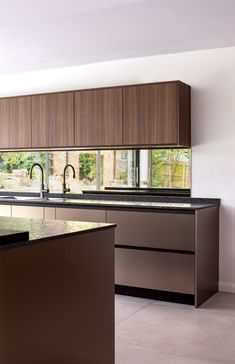 a modern kitchen with an island and sink