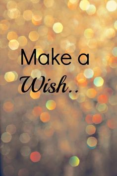 the words make a wish written on a blurry background