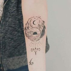 a woman with a tattoo on her arm and the moon in the sky above it