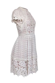 Get the perfect bridal tea look with this ivory eyelet lace dress from Rebecca Taylor. The scallop edge hem and short sleeves add a touch of elegance, while the beige lining provides comfort and coverage. Complete this timeless and sweet look with strappy sandal heels and pearl earrings. Size 4 Shell 100% Cotton Combo 100% Cotton Lining 100% Polyester Trim 100% Cotton Invisible zipper back Contrast color lining scallop lace hems Bust 34" Waist 28" Shoulder to hem 37" Sleeve length 7" Fitted Lace Dress With Scalloped Edges For Wedding, Lace Dress With Scalloped Edges And Short Sleeves, Short Sleeve Lace Dress With Scalloped Edges, White Fitted Lace Dress With Scalloped Edges, Fitted White Lace Dress With Scalloped Edges, Elegant Short Sleeve Lace Dress For Garden Party, White Lace Dress With Scalloped Edges For Summer, Delicate Lace Short Sleeve Summer Dress, Summer Short Sleeve Delicate Lace Dress