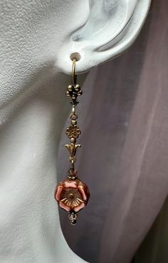 Brown floral Czech glass beaded earrings with antiqued brass floral connectors. These earrings are 2 1/8 inches long and come in a gift box or gift bag. Elegant Adjustable Flower Shaped Beaded Earrings, Vintage Gold Beaded Earrings, Copper Drop Earrings With Flower And Ear Wire, Copper Drop Flower Earrings With Ear Wire, Vintage Brown Flower-shaped Jewelry, Vintage Metal Flower Earrings For Pierced Ears, Vintage Brass Flower Earrings Nickel Free, Vintage Metal Beaded Earrings For Gift, Vintage Metal Flower Earrings