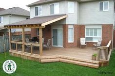 a wooden deck in front of a house