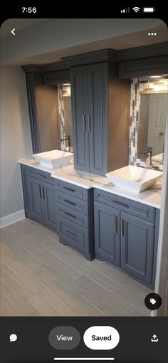 a bathroom with double sinks and two mirrors on the wall next to eachother