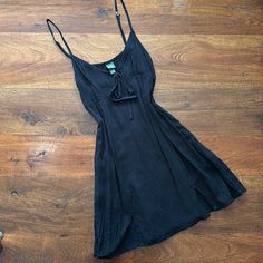 Women’s Black Mini Dress Never Worn Great Condition. Tie In The Front And Adjustable Straps Chic Black Slip Dress For Vacation, Black Mini Slip Dress For Brunch, Black Slip Dress For Summer Brunch, Casual Black V-neck Slip Dress, Black Mini Length Slip Dress For Beach, Casual Black Slip Dress For Beach, Casual Black Slip Dress For Vacation, Casual Black Slip Dress For Spring, Black Mini Slip Dress For Summer