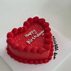 a heart shaped birthday cake with the words happy birthday written on it