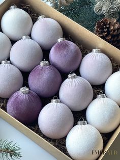 a box filled with purple and white ornaments