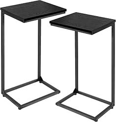 two black metal side tables with square tops on each end, one is turned upside down