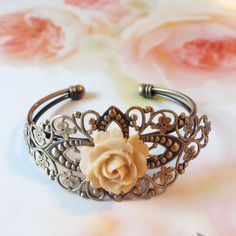 Elegant Bronze Bangle As Gift, Elegant Bronze Cuff Bracelet For Wedding, Handmade Cream Bangle Jewelry, Bohemian Cream Bangle Jewelry, Bohemian Cream Bangle, Handmade Flower Shaped Elegant Bangle, Handmade Elegant Flower Bangle, Elegant Cream Cuff Bracelet As Gift, Elegant Cream Cuff Bracelet Gift