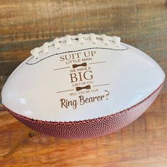 a white football sitting on top of a wooden table