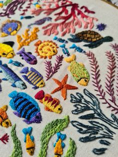 an embroidery project with colorful fish and plants