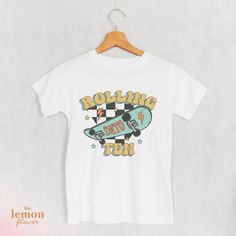 ♥ WELCOME TO THE LEMON FLOWER SHOP ♥ ------------------------------------------ PRODUCT ------------------------------------------ Looking for the perfect gift? Check out this awesome Skateboard T-Shirt designed for 10-year-olds! Whether they're out having a blast with friends or just hanging out, this tee adds a touch of skatepark style to their look. Made for comfort, it's the ideal present for young skaters who know how to rock their outfits. Get yours now and let the good times begin! ------------------------------------------ MATERIAL ------------------------------------------ Bella + Canvas Youth Staple Tee is light, comfy, and has just the right amount of stretch youngsters need for an active lifestyle. ⇢ 100% Airlume combed and ring-spun cotton ⇢ Heather colors are 52% combed and r Retro White T-shirt For Birthday, Old Skateboard, Skateboard Birthday, Lemon Flower, Tenth Birthday, Lemon Flowers, Skateboard Tshirt, Skate Park, Having A Blast