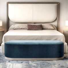 a bed with a blue footstool in a bedroom