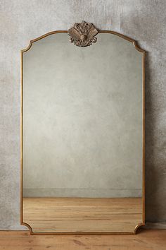 a mirror sitting on top of a wooden floor