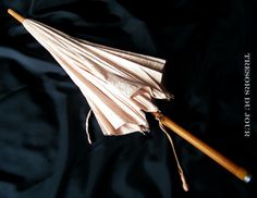 an open umbrella laying on top of a black cloth