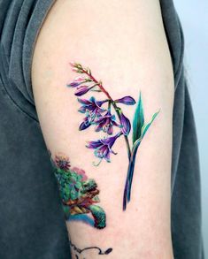 a close up of a person's arm with flowers on it