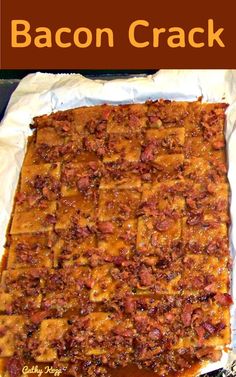 there is a very large square cake that has been cut into squares and placed on a piece of parchment paper