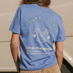 High quality vintage surf t-shirt. 100% organic cotton. Unisex sizes. Made in Los Angeles. Casual Blue Tops With Back Print, Summer Relaxed Fit Top With Front And Back Print, Relaxed Fit Summer Top With Front And Back Print, Graphic Print Top For Beach Season, Casual Tops With Front And Back Print For Summer, Relaxed Fit Cotton T-shirt For Surfing, Cotton Tops For Outdoor Beach Season, Blue Relaxed Fit Surfing T-shirt, Casual Cotton Surfing T-shirt