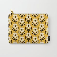 a yellow and black floral pattern carry - all pouch with white flowers on the front