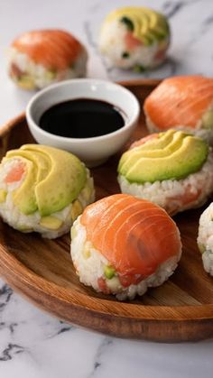 sushi on a wooden plate with dipping sauce