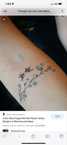 a small tattoo with blue flowers on it