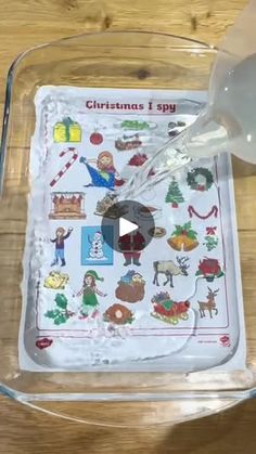 someone is pouring wine into a glass on top of a tray with christmas stickers