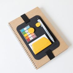 a notepad with a pen and some other items on it