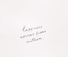 a white wall with writing on it that says happiness comes from within