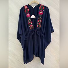 Elevate Your Wardrobe With This Stunning Umgee Kimono Cardigan Cover-Up. The Beautiful Blue Floral Pattern Is Complemented By Intricate Embroidery, Adding A Touch Of Elegance To Any Outfit. The Tie Closure Allows For A Customizable Fit And Easy Wear, While The M/L Size Is Perfect For A Comfortable And Relaxed Fit. This Blouse Is A Must-Have For Any Fashion-Forward Woman, And Its Versatile Style Makes It Suitable For Any Occasion. N66 654 Blue Floral Embroidered V-neck Kaftan, Summer Blue Kaftan With Floral Embroidery, Blue V-neck Kaftan With Floral Embroidery, Bohemian Blue Kimono With Floral Embroidery, Blue Bohemian Kimono With Floral Embroidery, Summer Kimono With Multicolor Floral Embroidery, Blue Floral Embroidered Kimono For Spring, Blue Long Sleeve Kimono With Floral Embroidery, Blue Embroidered Kimono For The Beach