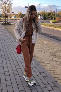 woman wearing light brown jumpsuit with trainers and cream-colored fleece jacket Feeling Inspired, Feel Inspired, Jumpsuit, Ootd, One Piece, Lifestyle