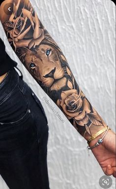 a man with a tattoo on his arm holding the hand of a woman's forearm