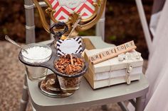 a chair with some food on top of it next to a stack of books and other items