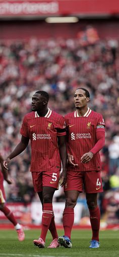 two soccer players are standing on the field