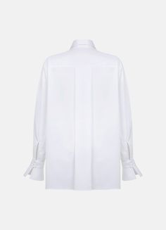 The elegant gem of our collection is the Quita white shirt. It features an airy flounce draping in the front, reminiscent of a descending wave. Highlighted by exquisite details such as bell-shaped cuffs and a classic collar, this shirt will make youк outfit stand out while providing the comfort of luxurious organic cotton satin fabric. Features: Oversize design Long sleeves Bell shaped buttoned cuffs Concealed button closure Classic collar Frontal flounce detailing Made from cotton satin Premium Luxury White Workwear Blouse, Luxury White Blouse For Work, Luxury White Office Tops, Timeless White Blouse For Work, Timeless White Formal Blouse, Timeless White Tops For Daywear, Timeless White Office Tops, Elegant White Blouse For Daywear, Timeless White Tops For Workwear