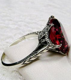 Simulated Red Ruby Ring Description 100 Year Design#37 Custom This is a brand new Edwardian reproduction filigree ring in antiqued solid sterling silver. The round full cut high quality Simulated/man-made red ruby gemstone is 12mm (1/2th of an inch) in diameter. The inside of the band is marked 925 for sterling. Notice the beautiful intricate crown like design of the silver filigree setting and etched band. The original ring I bought in this exact design was from 1910. This is a rare and exact r Red Ruby Ring, Rubin Ring, Unique Rings Vintage, Edwardian Jewelry, Red Gemstones, Filigree Ring, Victorian Jewelry, Red Ruby, Engraved Items