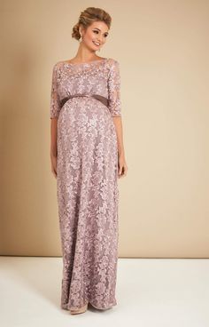 Made from beautiful vintage-inspired sheer lace, the Asha in Lilac is a stunning floor-length gown. From Baby Shower to Bridesmaid, with a stylish boat neckline, sheer ¾ length sleeves and dramatic full skirt that drapes over your bump, you’ll look and feel amazing at the most special of occasions. •Premium embroidered tulle in lilac •Floor length gown with ¾ sleeves •Empire waist with gentle gather over the bump •Sheer neckline and sleeves •Fully lined with premium jersey •Add a sash to define Floor-length Lace Gown For Mother Of The Bride, Floor-length Mother Of The Bride Dress With Lace Sleeves, Lace Maternity Maxi Dress For Wedding, Lace Maternity Wedding Dress With Scalloped Lace, Elegant Lace Maternity Wedding Dress, Lace Maternity Dress With Lace Bodice For Wedding, Maternity Wedding Dress With Lace Bodice, Wedding Maternity Dress With Lace Bodice, Lace Maxi Dress For Mother Of The Bride