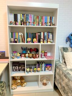 a white book shelf filled with lots of books