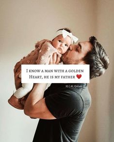 a man holding a baby in his arms with the caption i know a man with a golden heart, he is my father