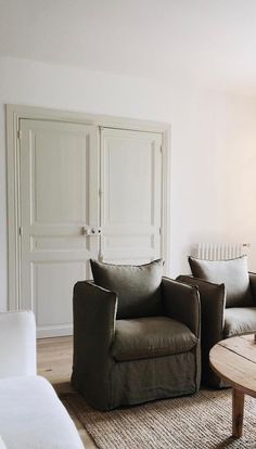 a living room filled with furniture and white walls